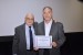 Dr. Nagib Callaos, General Chair, giving Prof. Detlev Doherr the best paper award certificate of the session "ICT Applications in Complexity, Risk Management and Engineering." The title of the awarded paper is "Artificial Intelligence - Changing Humanism."